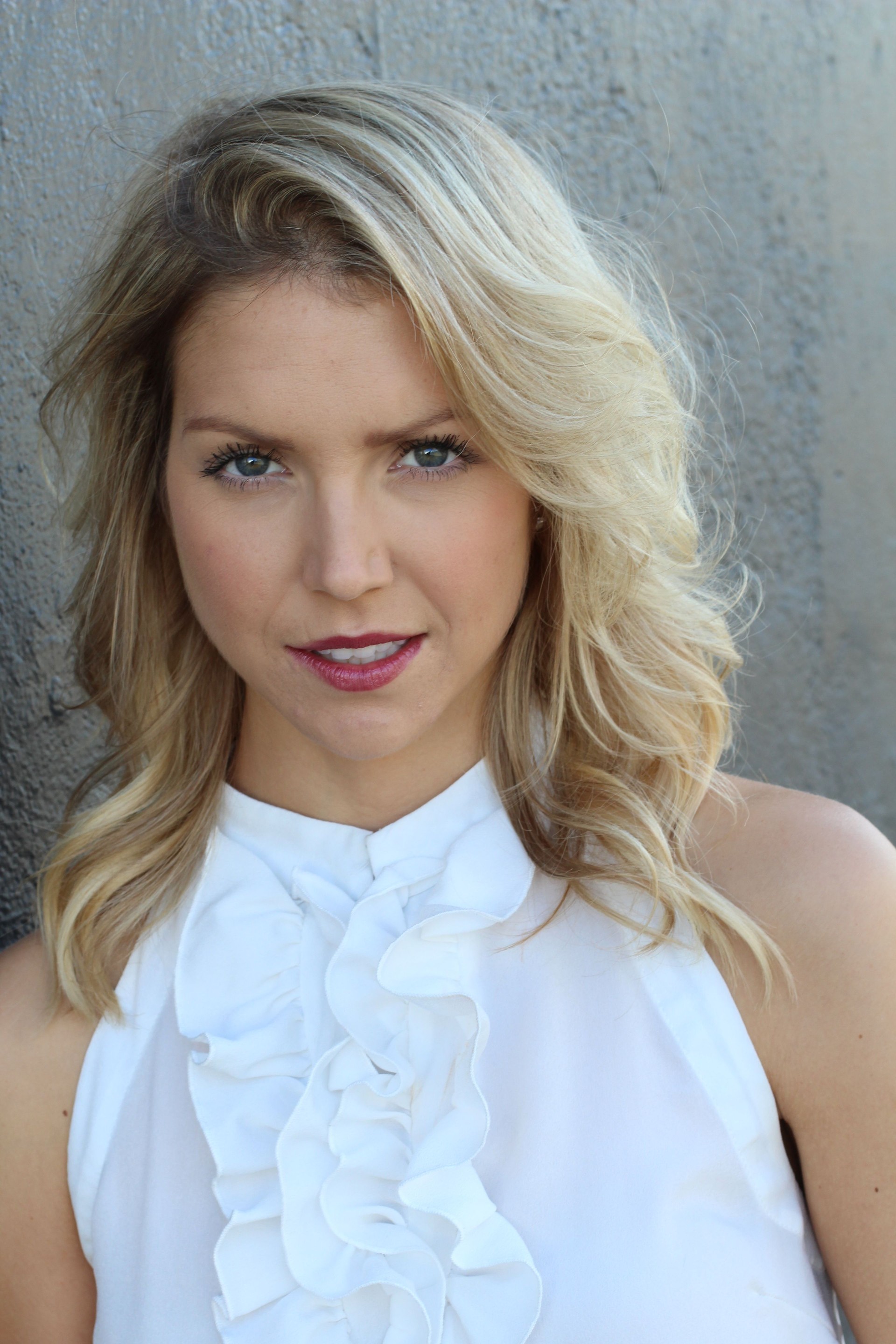 Blond woman in classy white silk blouse