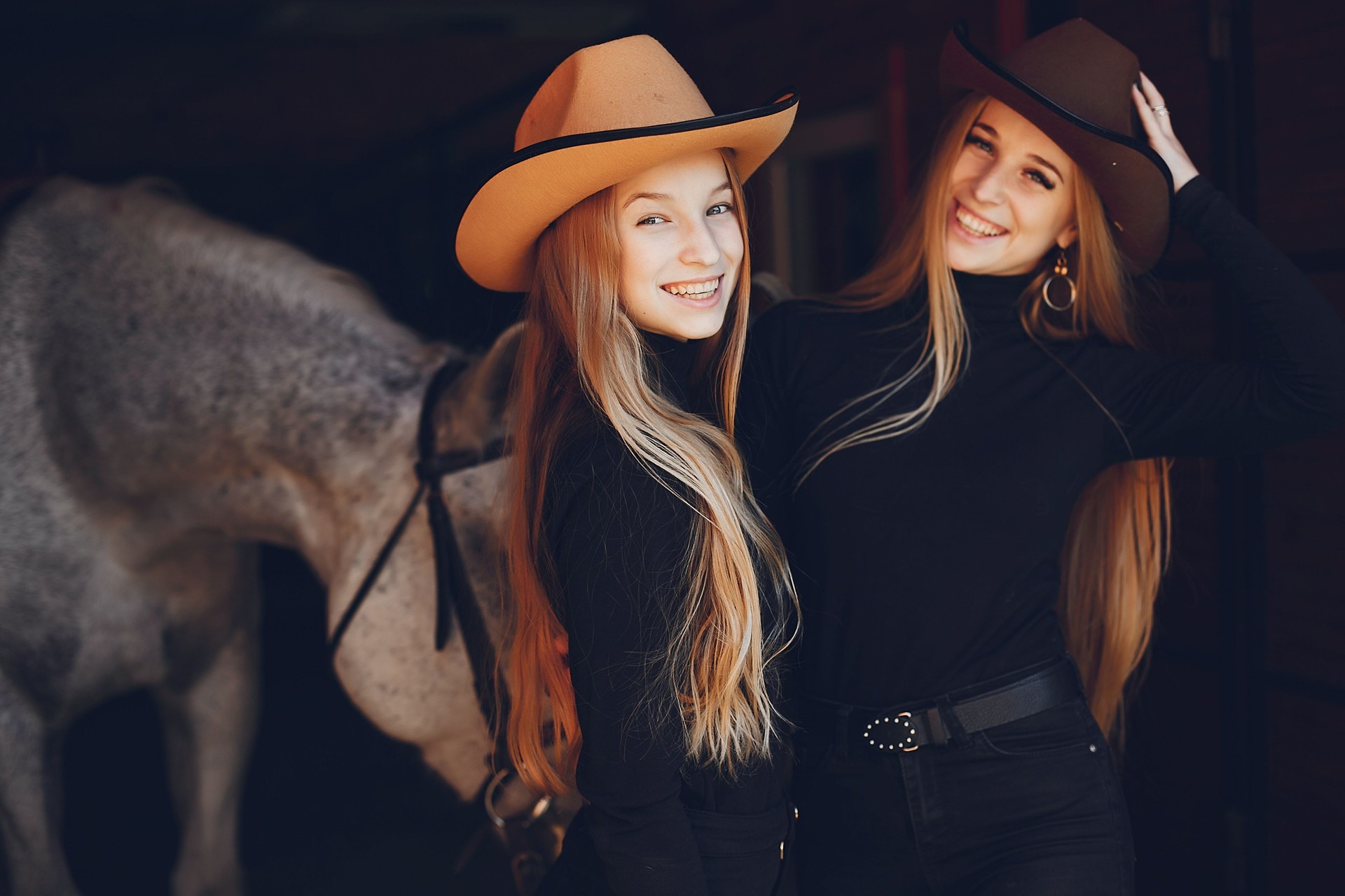 Elegant girls with a horse in a ranch