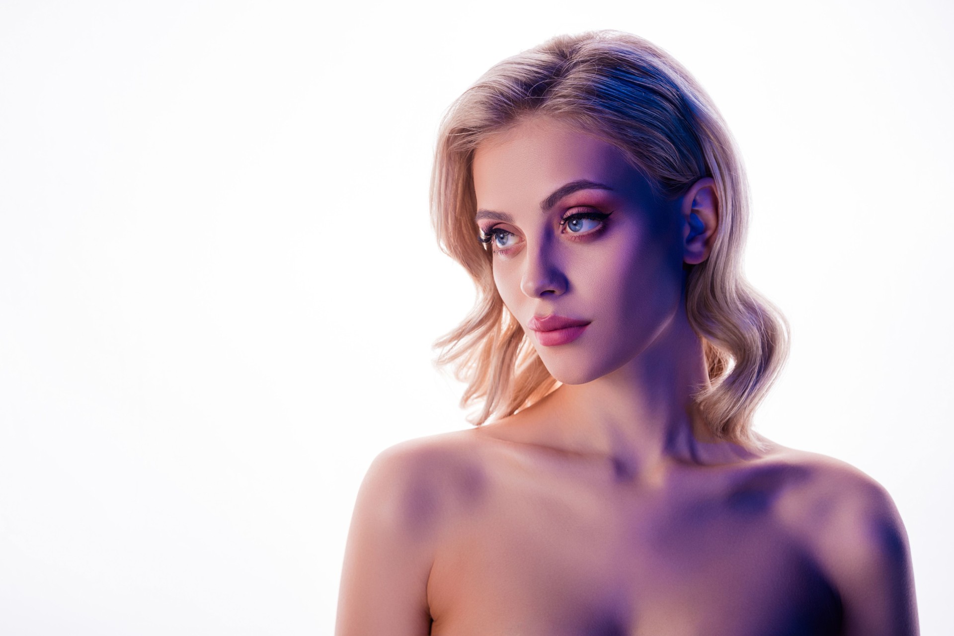 Photo of attractive pretty girl with blonde hair curls look profile side empty space white color background