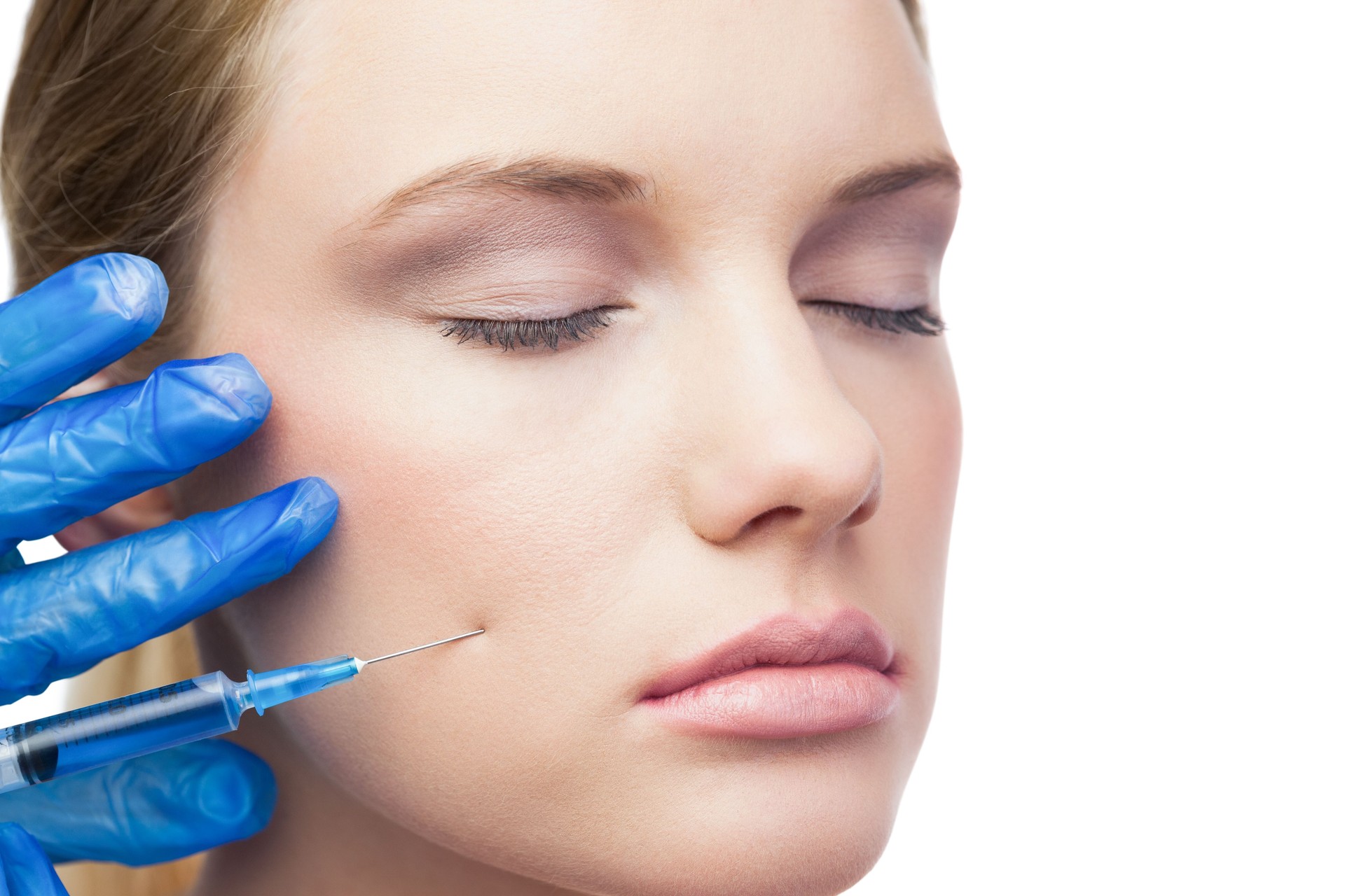 Peaceful cute model having botox injection on the cheek