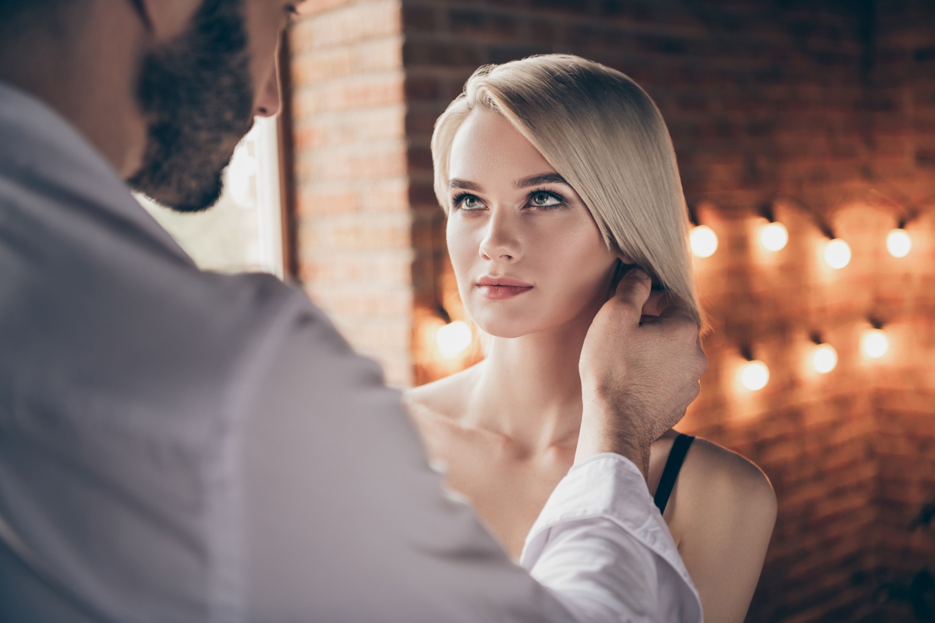 Close-up portrait of two person nice-looking sweet stunning shine gorgeous attractive lovely lady having affair with guy soulmate in loft brick industrial style interior room house hotel