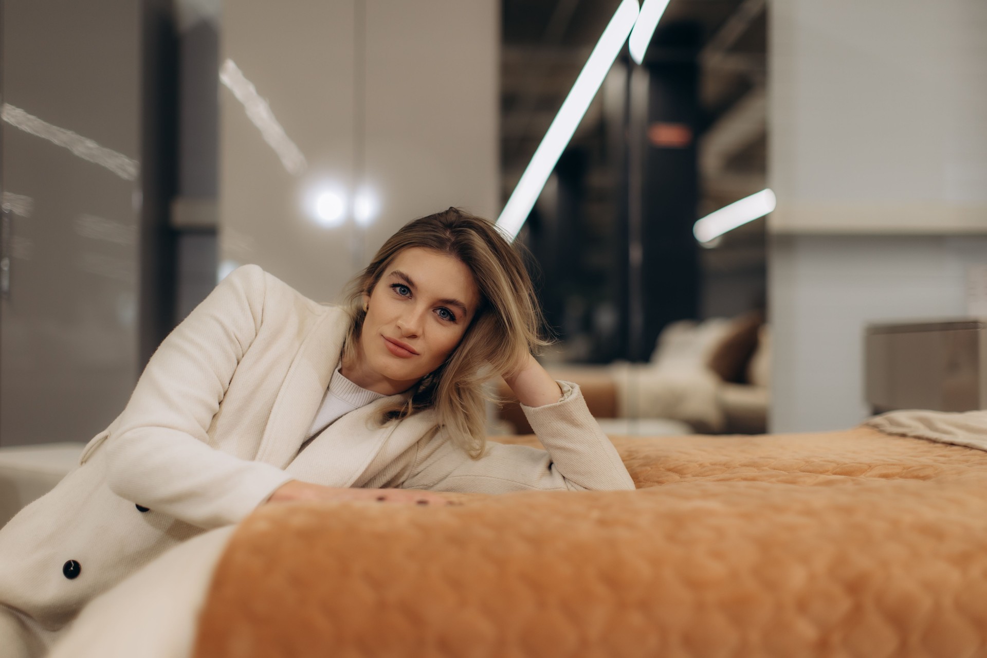 Woman Relaxing on a Stylish Bed in a Cozy Modern Setting