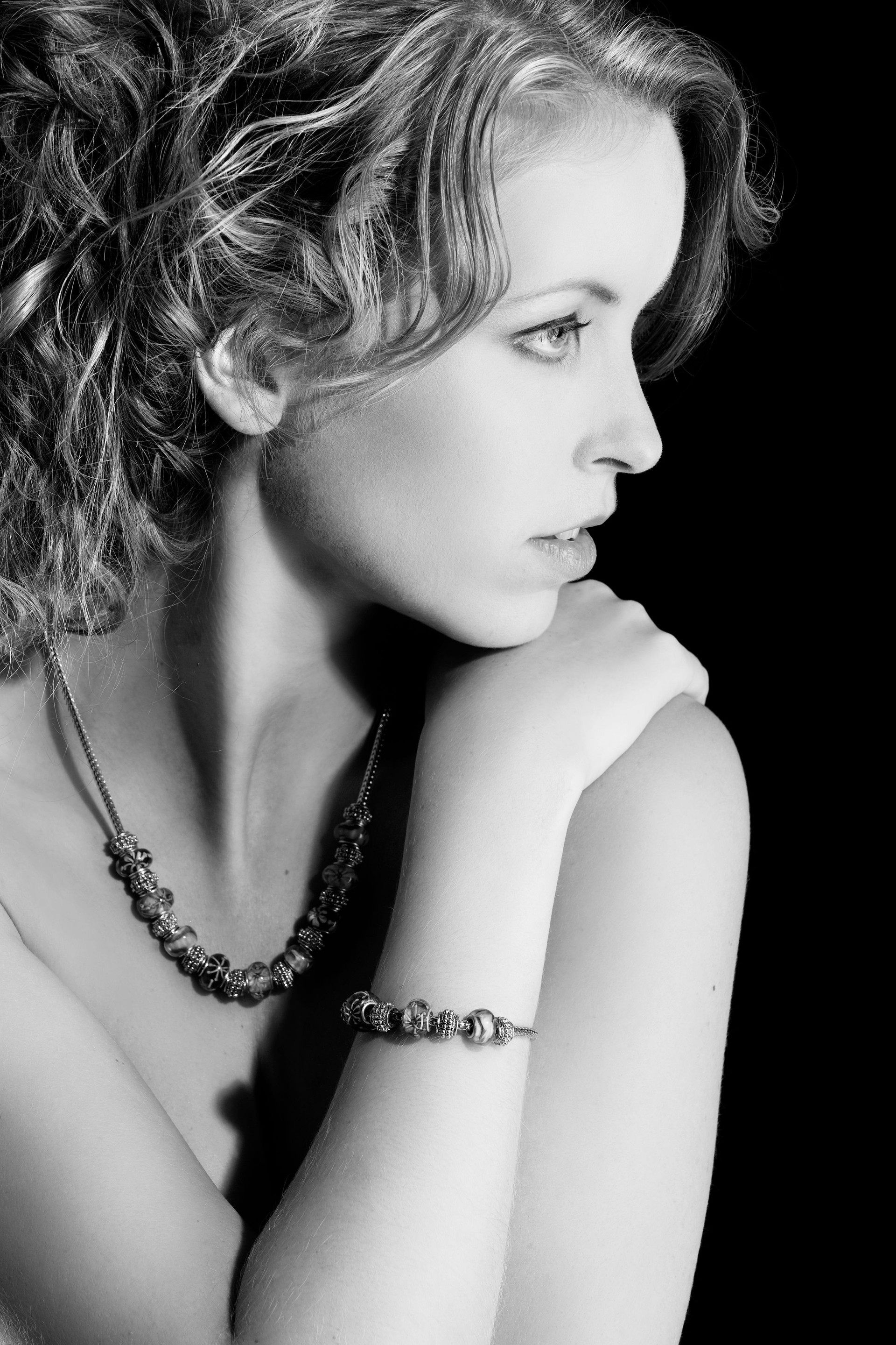 Beautiful young girl with necklace posing in studio
